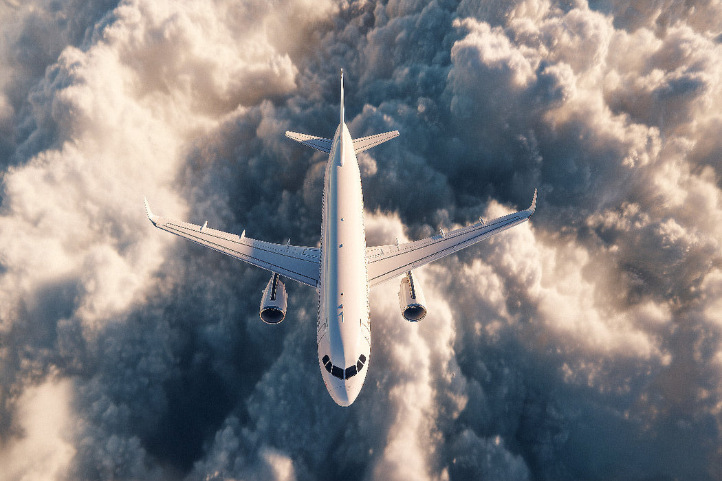 Premium Textil-Leinwand Flugzeug über den Wolken im Gegenlicht