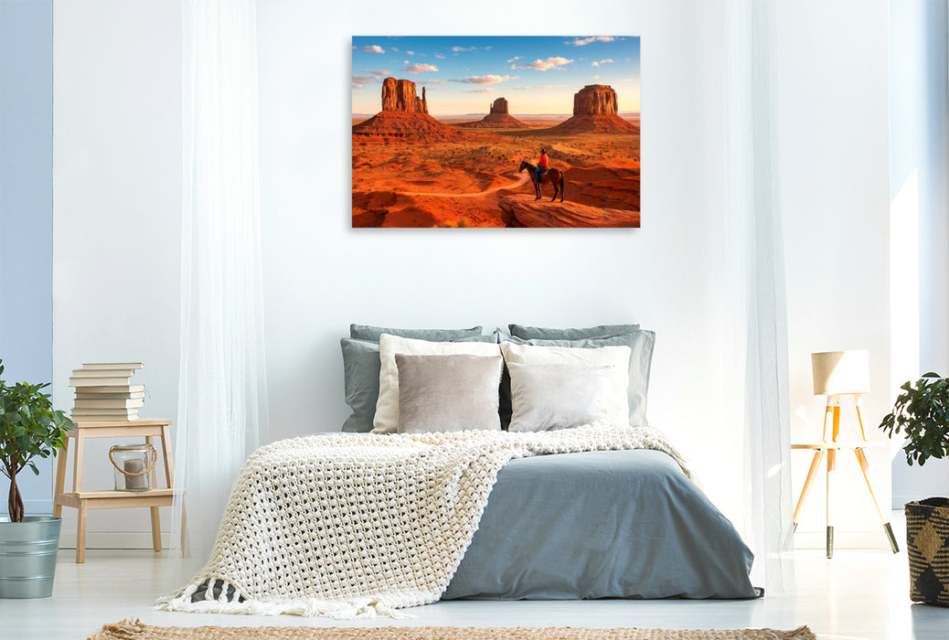 Premium Textil-Leinwand Monument Valley – Im Land der roten Riesen. Ein Cowboyblick über die Weiten des Wilden Westens