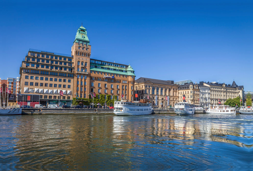 Premium textile canvas Premium textile canvas 120 cm x 80 cm landscape harbor of Stockholm with historic hotel and ferry boats 